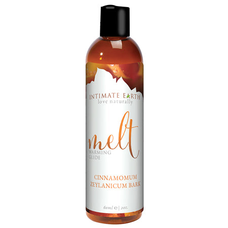 Bottle of Intimate Earth Melt Warming Glide with Cinnamomum Zeylanicum bark extract. The label is white with orange and cinnamon graphics and text.