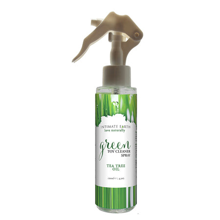 A clear plastic spray bottle with a green label, white text, and a gold-colored spray pump. The label reads 'Intimate Earth Green Toy Cleaner Spray with Tea Tree Oil'.