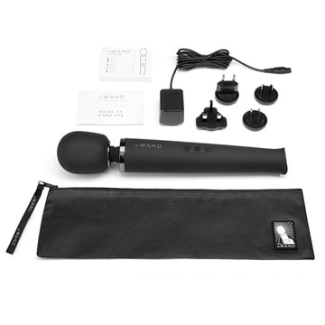 A black Le Wand rechargeable vibrating massager with a wired remote control and various accessories, including a silicone head, neck flex, and a black textured cover.