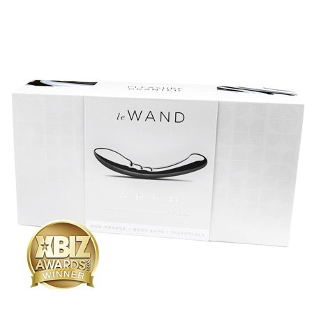 The product image shows the packaging of the Le Wand Arch Stainless Steel Massager, with the massager itself displayed on the front. The packaging is predominantly white and has the Le Wand brand logo, award recognitions, and a description of the product.