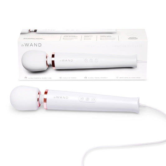 A white Le Wand Plug-In Vibrating Massager with a flexible neck and a control panel. The product is shown both inside its packaging and separately.