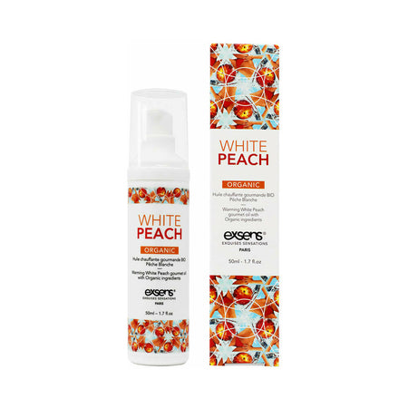 A bottle of Exsens Warming Massage Oil with White Peach flavor, featuring a design with peach flowers on the label.