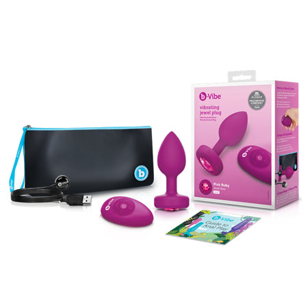 The image shows a pink vibrating anal plug with a gem base, a black and blue carrying case, and the product's packaging box.
